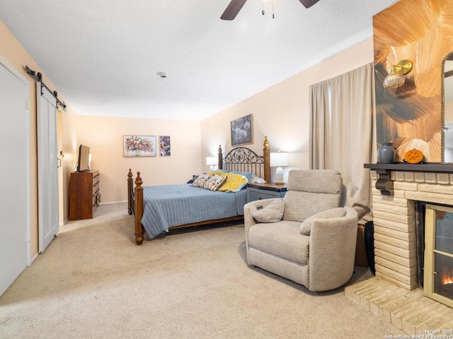 7906 Winsford, San Antonio, TX 78239 - carpeted bedroom featuring a ceiling fan, a fireplace, and a barn door