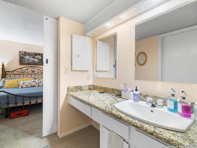 7906 Winsford, San Antonio, TX 78239 - bathroom featuring baseboards, vanity, and a textured ceiling