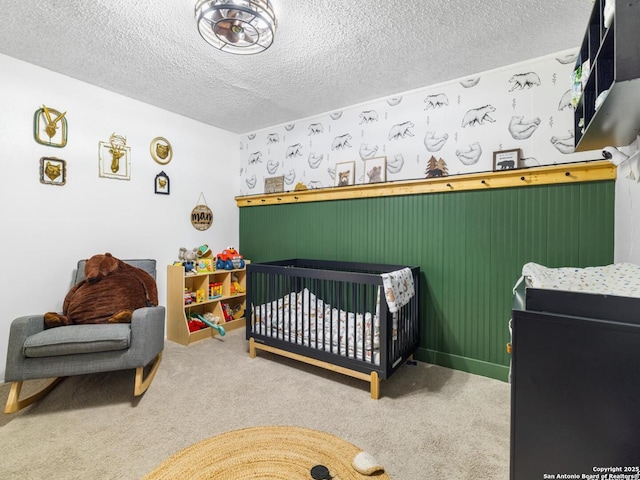 7906 Winsford, San Antonio, TX 78239 - carpeted bedroom with a crib and a textured ceiling