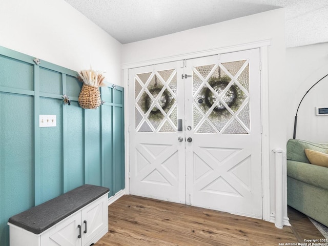 7906 Winsford, San Antonio, TX 78239 - mudroom featuring wood finished floors and a textured ceiling