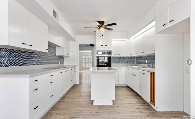 kitchen with oven, visible vents, decorative backsplash, a ceiling fan, and dishwasher