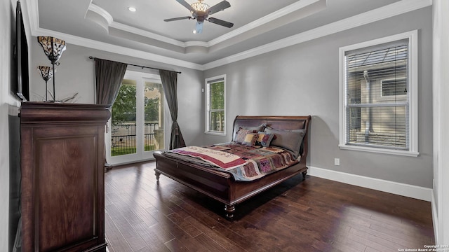 bedroom featuring hardwood / wood-style floors, access to outside, a raised ceiling, and crown molding