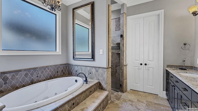 bathroom featuring a stall shower, stone finish floor, a tub with jets, crown molding, and vanity