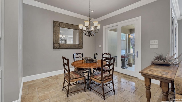 dining space with stone tile floors, baseboards, a notable chandelier, and crown molding