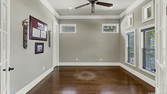 spare room featuring baseboards, a ceiling fan, dark wood-style floors, and ornamental molding