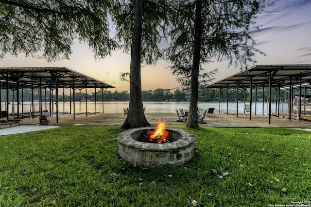 exterior space with a fire pit and a water view