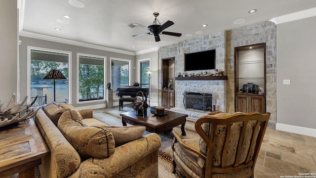 living room featuring recessed lighting, stone tile floors, a stone fireplace, a ceiling fan, and baseboards