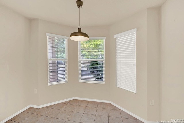 8906 Mission Brk, San Antonio, TX 78223 - unfurnished dining area featuring baseboards and light tile patterned floors