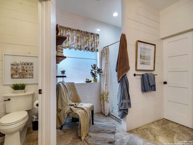 286 Iron Kettle, Universal City, TX 78148 - bathroom featuring wooden walls, toilet, and a shower with curtain