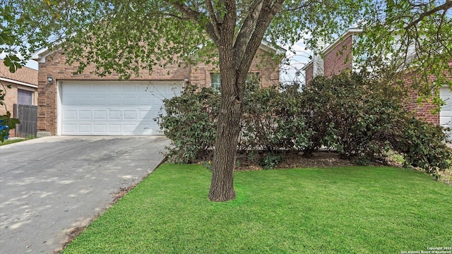 6430 Ithaca Fls, San Antonio, TX 78239 - obstructed view of property with brick siding, driveway, a front yard, and a garage