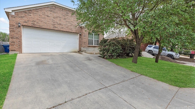 6430 Ithaca Fls, San Antonio, TX 78239 - view of front of home with a garage, a front lawn, brick siding, and concrete driveway