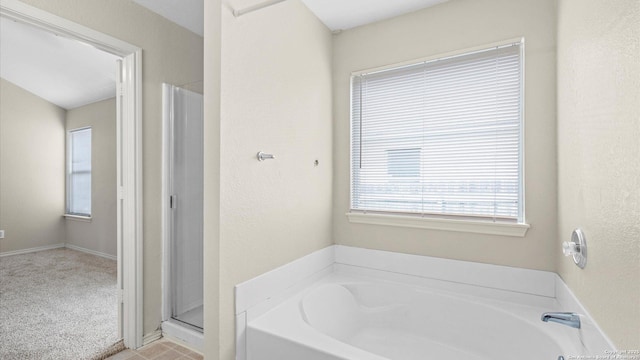 6430 Ithaca Fls, San Antonio, TX 78239 - bathroom featuring a garden tub, baseboards, and a shower stall