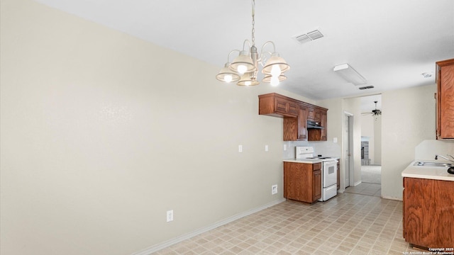 6430 Ithaca Fls, San Antonio, TX 78239 - kitchen featuring visible vents, ceiling fan with notable chandelier, light countertops, under cabinet range hood, and white range with electric cooktop