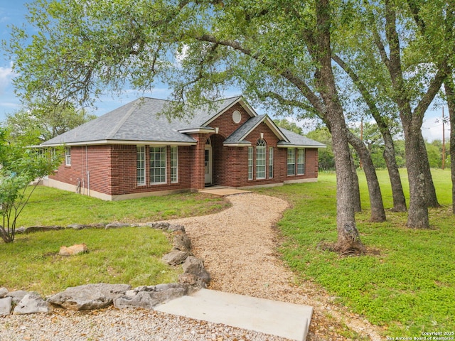 154 Elk Rdg, Canyon Lake, TX 78133 - single story home with brick siding, a shingled roof, and a front lawn