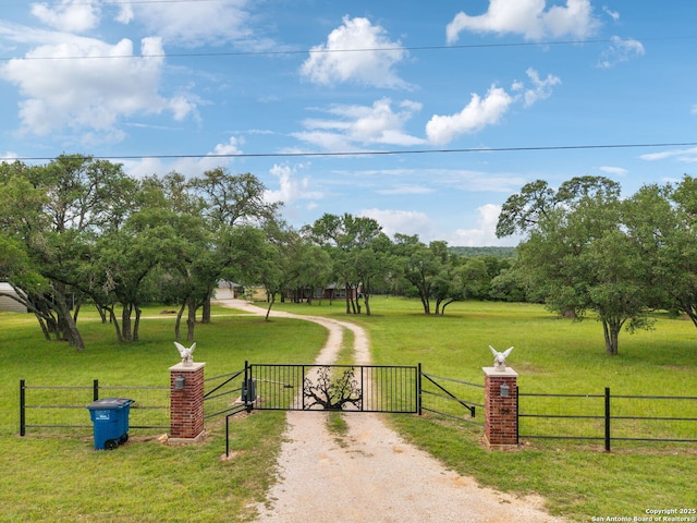 154 Elk Rdg, Canyon Lake, TX 78133 - view of home's community with a gate, a lawn, and fence
