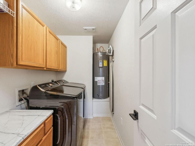 154 Elk Rdg, Canyon Lake, TX 78133 - washroom with washer and clothes dryer, a textured ceiling, water heater, cabinet space, and visible vents