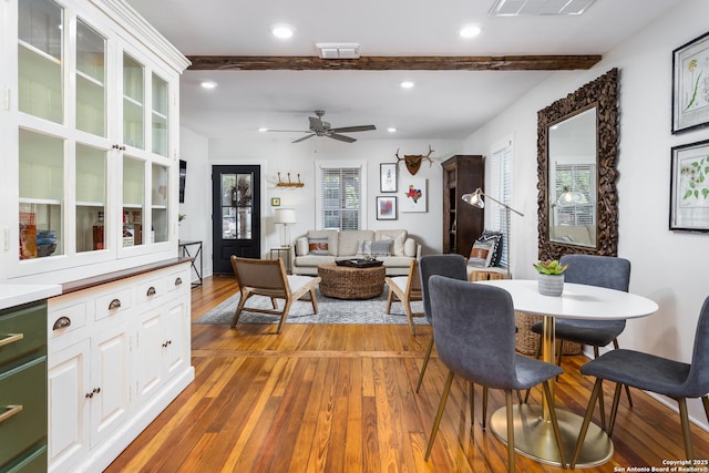 dining area featuring light wood-type flooring, visible vents, recessed lighting, beamed ceiling, and ceiling fan
