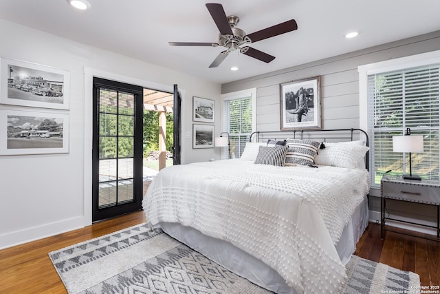 bedroom with wood finished floors, recessed lighting, and access to exterior
