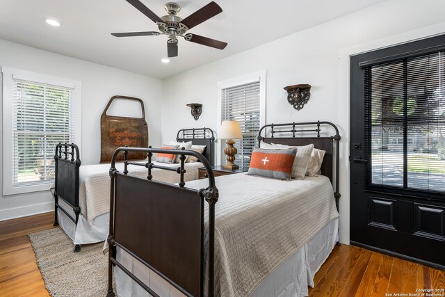 bedroom with recessed lighting, wood finished floors, baseboards, and ceiling fan