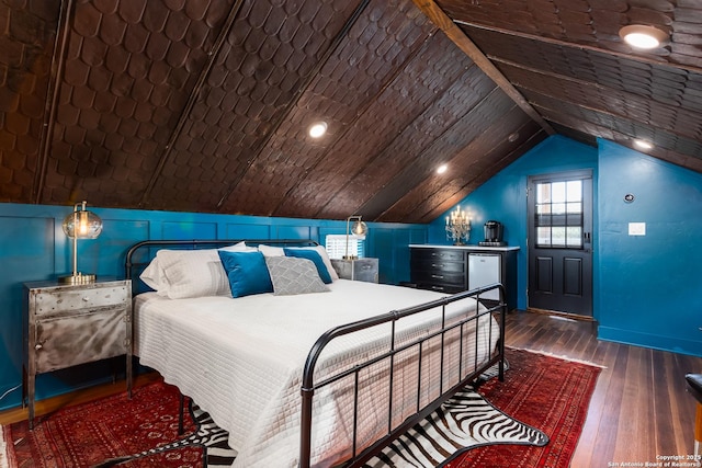 bedroom featuring lofted ceiling and wood-type flooring