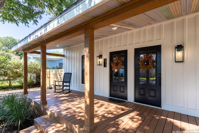entrance to property featuring a porch and board and batten siding