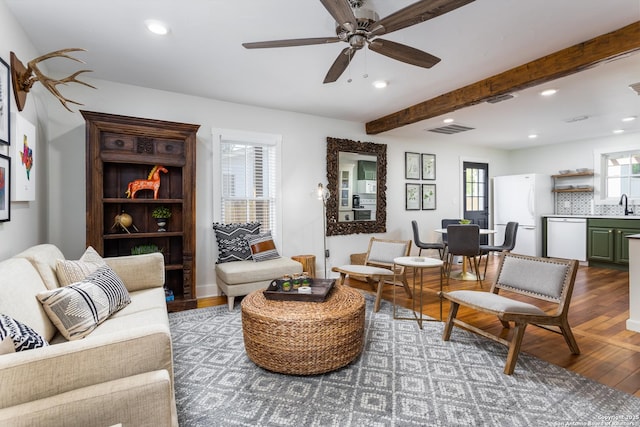 living area featuring beamed ceiling, wood finished floors, visible vents, and recessed lighting