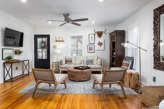 living area with recessed lighting, light wood-style flooring, a ceiling fan, and baseboards