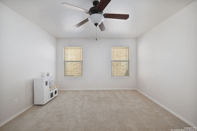 13219 Loma Sierra, San Antonio, TX 78233 - spare room featuring light carpet, a ceiling fan, and baseboards