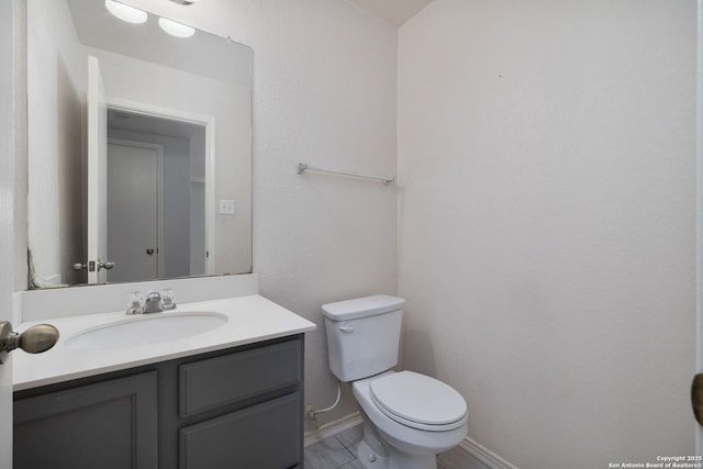 13219 Loma Sierra, San Antonio, TX 78233 - bathroom featuring baseboards, vanity, and toilet