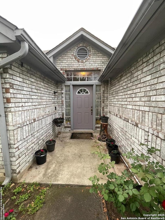 entrance to property with brick siding