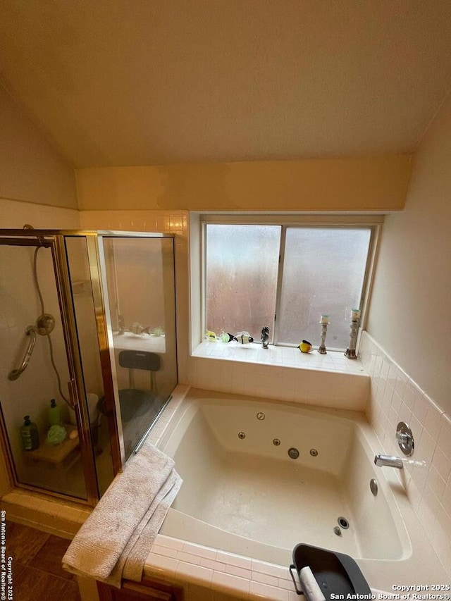 bathroom featuring a whirlpool tub and a shower stall