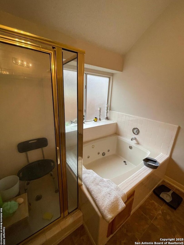 bathroom with a whirlpool tub, tile patterned floors, and a stall shower