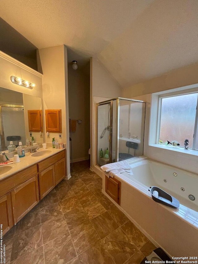 full bathroom featuring a shower stall, vaulted ceiling, double vanity, a tub with jets, and a sink