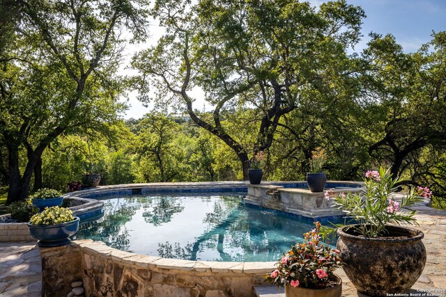 outdoor pool featuring a hot tub