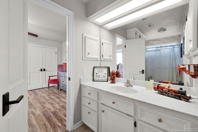 full bath featuring visible vents, wood finished floors, and vanity