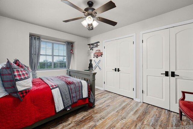 bedroom featuring wood finished floors, a ceiling fan, and baseboards
