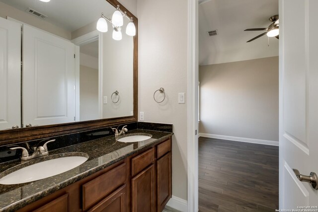 bathroom with a ceiling fan, a sink, and visible vents