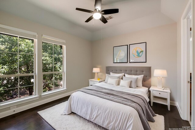 bedroom with visible vents, a ceiling fan, baseboards, and dark wood-style floors