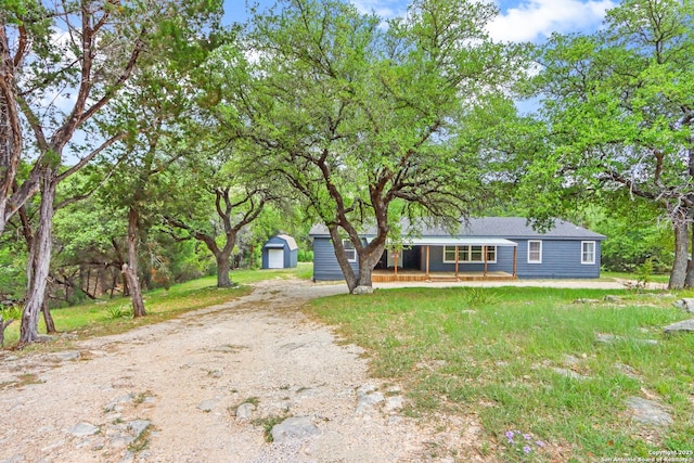 630 Nelson, Canyon Lake, TX 78133 - manufactured / mobile home with dirt driveway, a storage shed, an outdoor structure, covered porch, and a garage