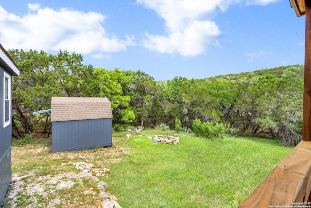 630 Nelson, Canyon Lake, TX 78133 - view of yard featuring an outbuilding, a wooded view, and a storage unit