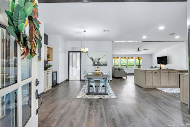 630 Nelson, Canyon Lake, TX 78133 - dining room featuring ceiling fan with notable chandelier, wood finished floors, and visible vents