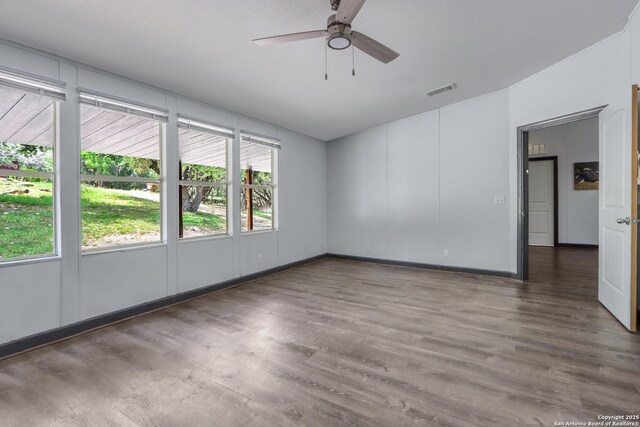 630 Nelson, Canyon Lake, TX 78133 - spare room with ceiling fan, baseboards, wood finished floors, and visible vents