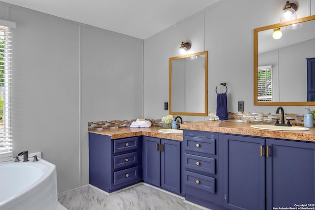 630 Nelson, Canyon Lake, TX 78133 - bathroom featuring a washtub, marble finish floor, a sink, and double vanity