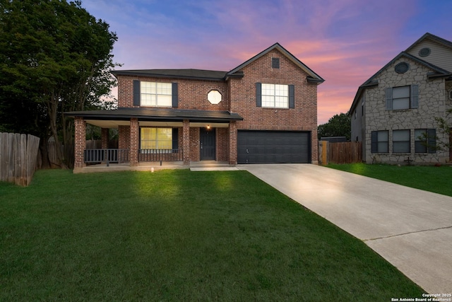 traditional-style home with a lawn, a porch, concrete driveway, and fence
