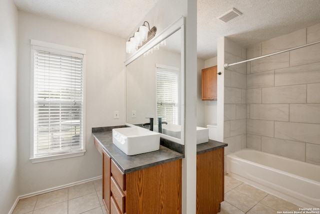 full bathroom featuring a textured ceiling, visible vents, tile patterned floors, and a healthy amount of sunlight