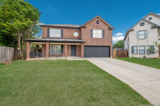 traditional home featuring fence, a front yard, driveway, and a garage