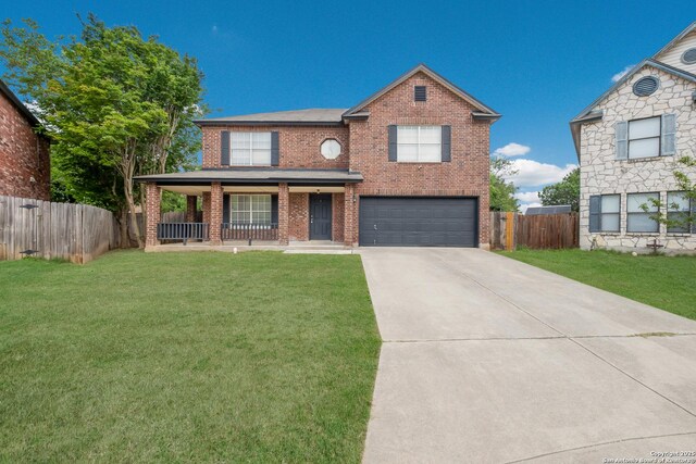 traditional home with a garage, concrete driveway, a porch, a front yard, and brick siding