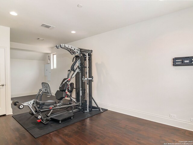 exercise room with recessed lighting, wood finished floors, visible vents, and baseboards