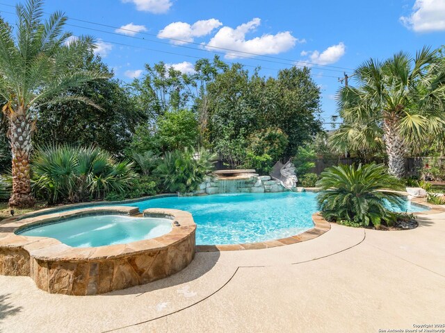 view of swimming pool featuring a pool with connected hot tub