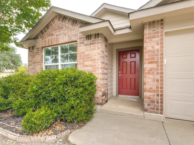 542 Snowy Egret, San Antonio, TX 78253 - view of exterior entry with an attached garage and brick siding